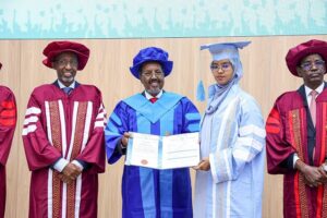 The President of Somalia presenting a certificate to one of the young women who graduated in security studies